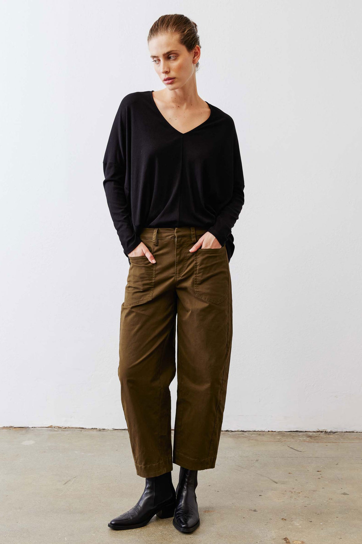 Black ribbed dolman long sleeve top with V-neck, loose drape and cuffs