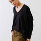 Black ribbed dolman long sleeve top, deep V-neck and side drape