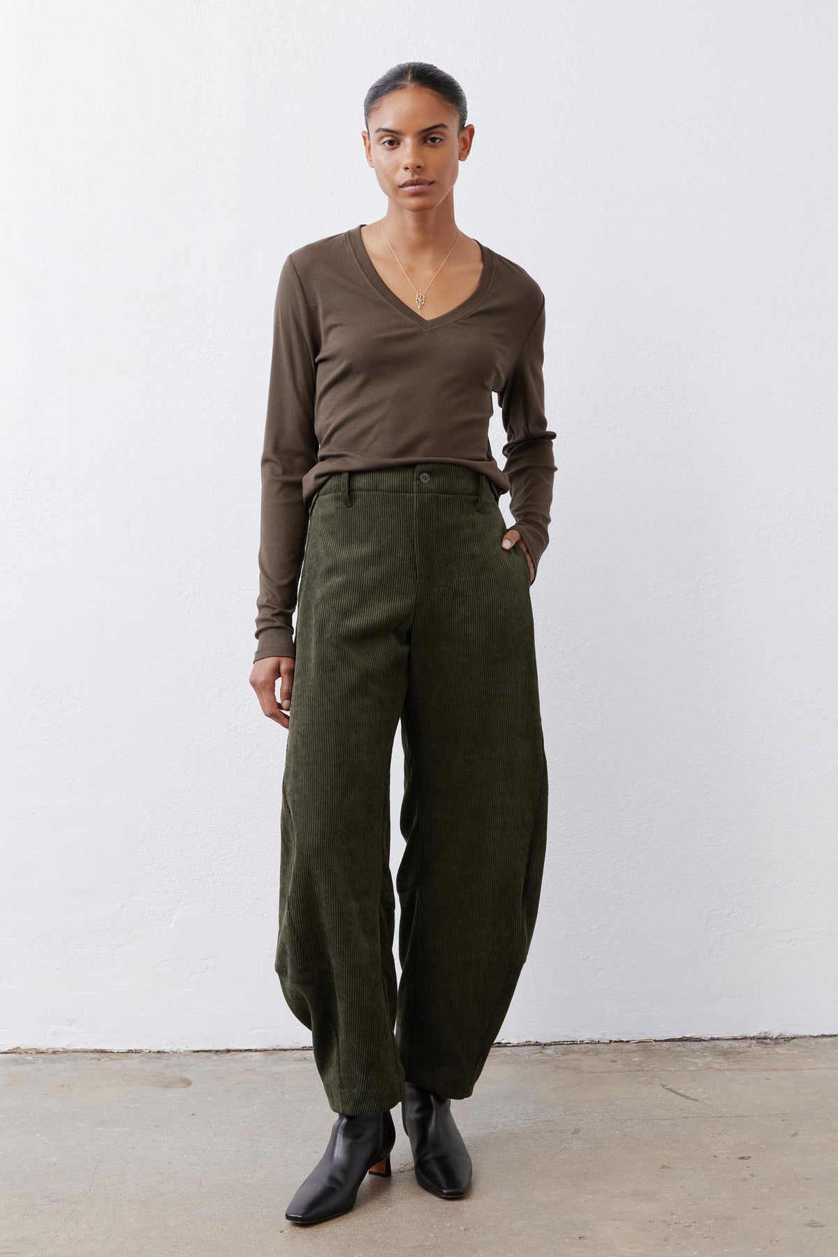 Olive-brown ribbed long-sleeve V-neck top with fitted neckline