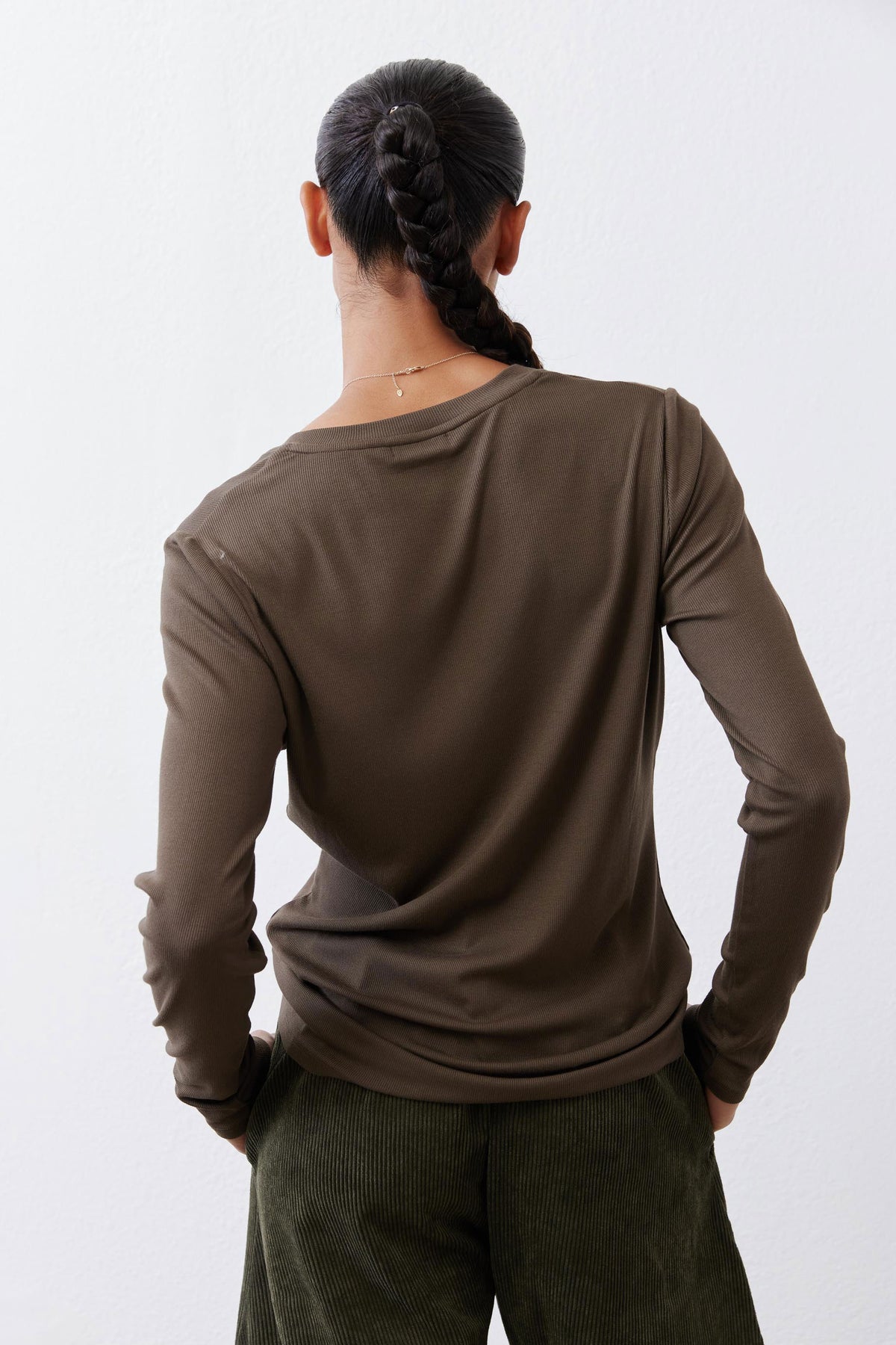 Olive-brown ribbed V-neck long-sleeve top, back view with neckline