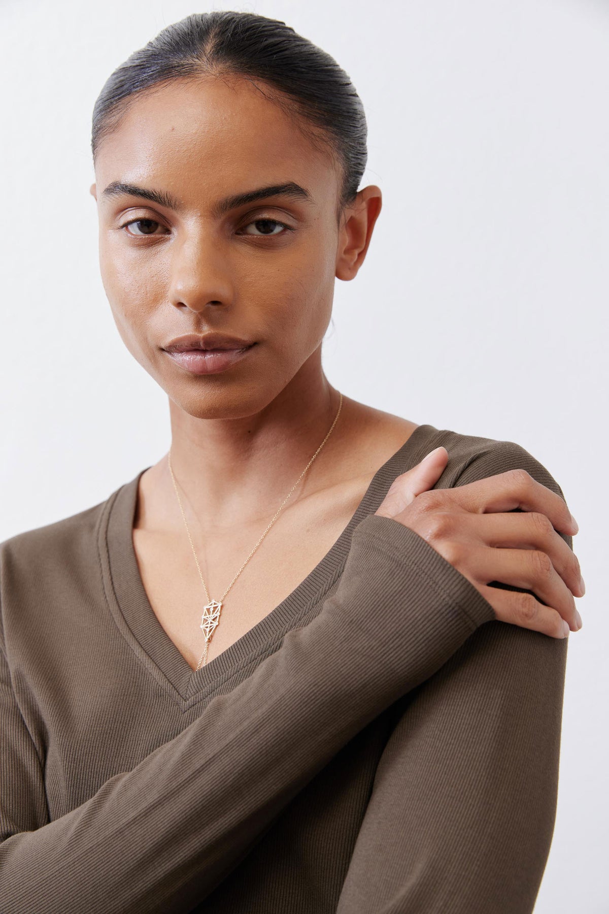 Olive-brown ribbed V-neck long-sleeve top, neckline and collar detail