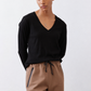 Black ribbed long-sleeve V-neck top with relaxed fit at the torso