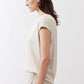 Light cream ribbed tee side view, short sleeves and draped hem