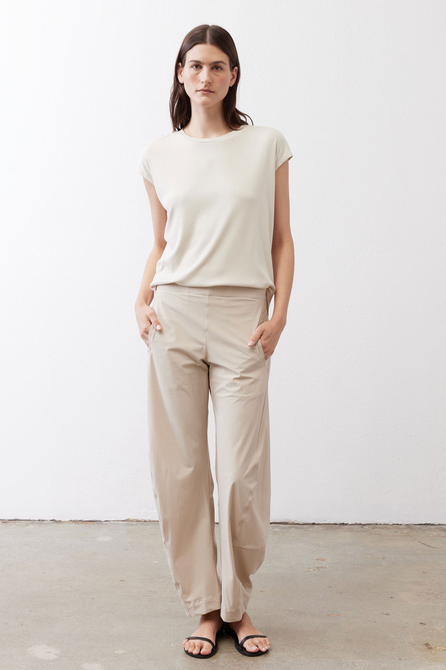 Light cream crewneck ribbed tee with short sleeves, worn with ankle pants