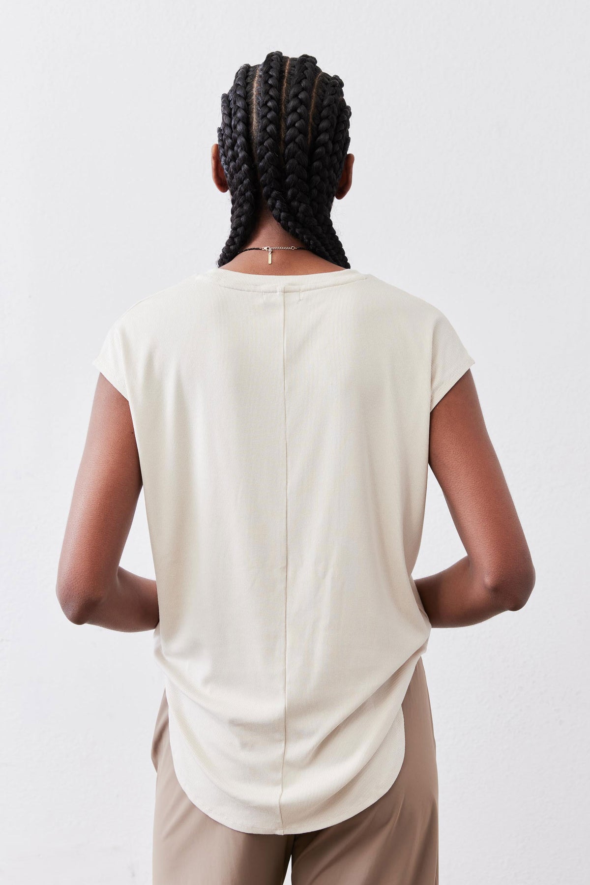 Light cream ribbed tuck-in tee, back view with crew neck and short sleeves