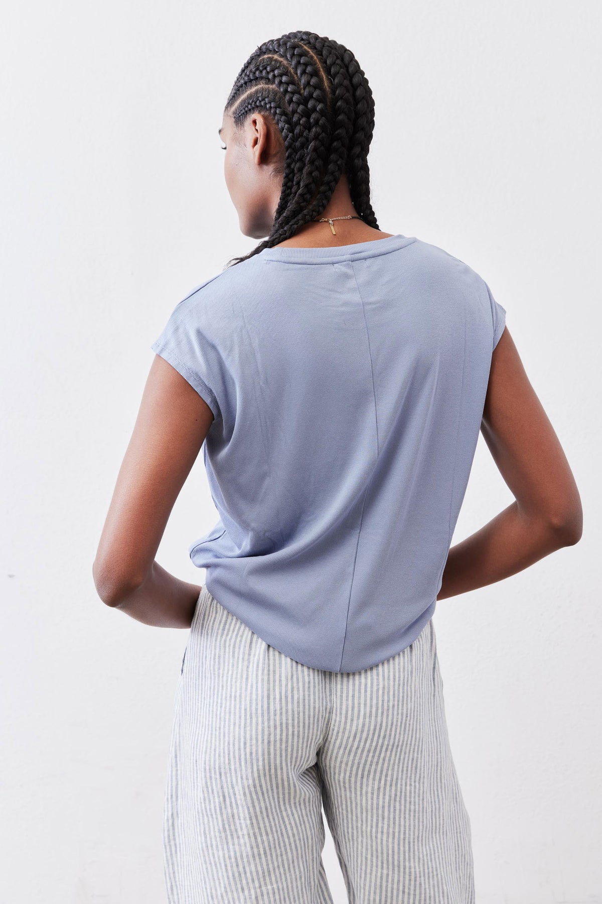 Light blue ribbed crew-neck tee with short sleeves, back view drape