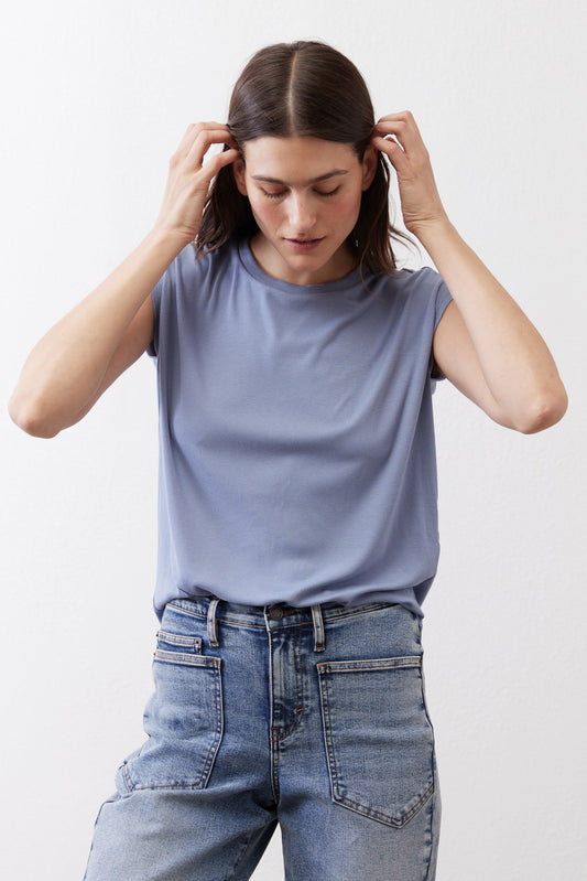 Cottage blue ribbed tuck-in tee with short sleeves and crew neck, tucked into jeans
