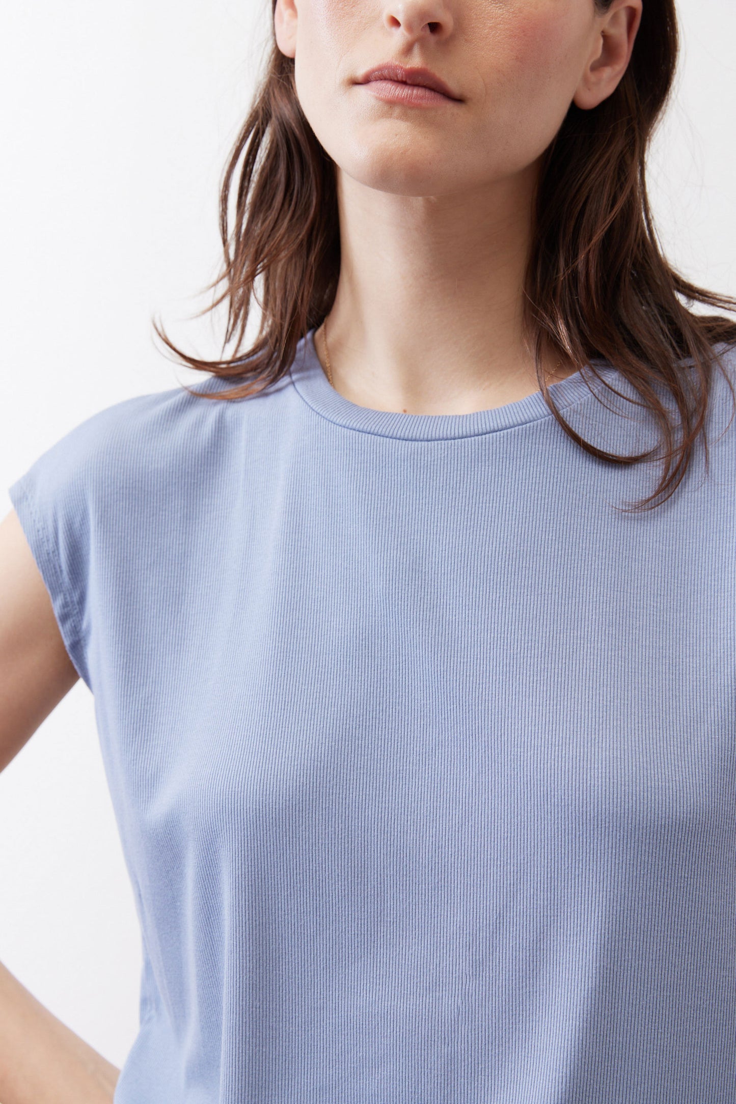 Light blue ribbed crew-neck tee with short sleeves, close-up knit texture