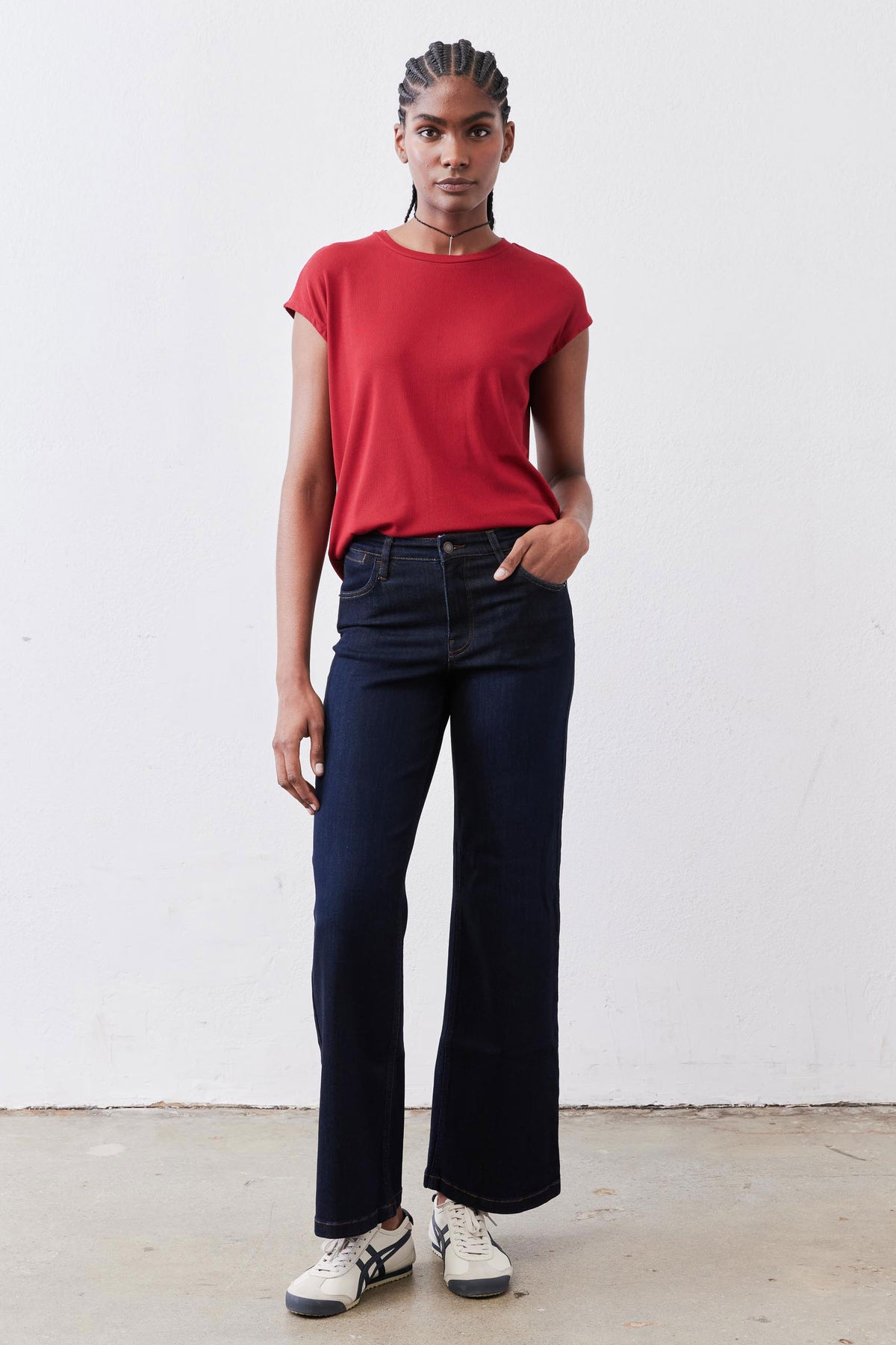 Garnet red ribbed crew-neck tee, short sleeves, tucked at waistband