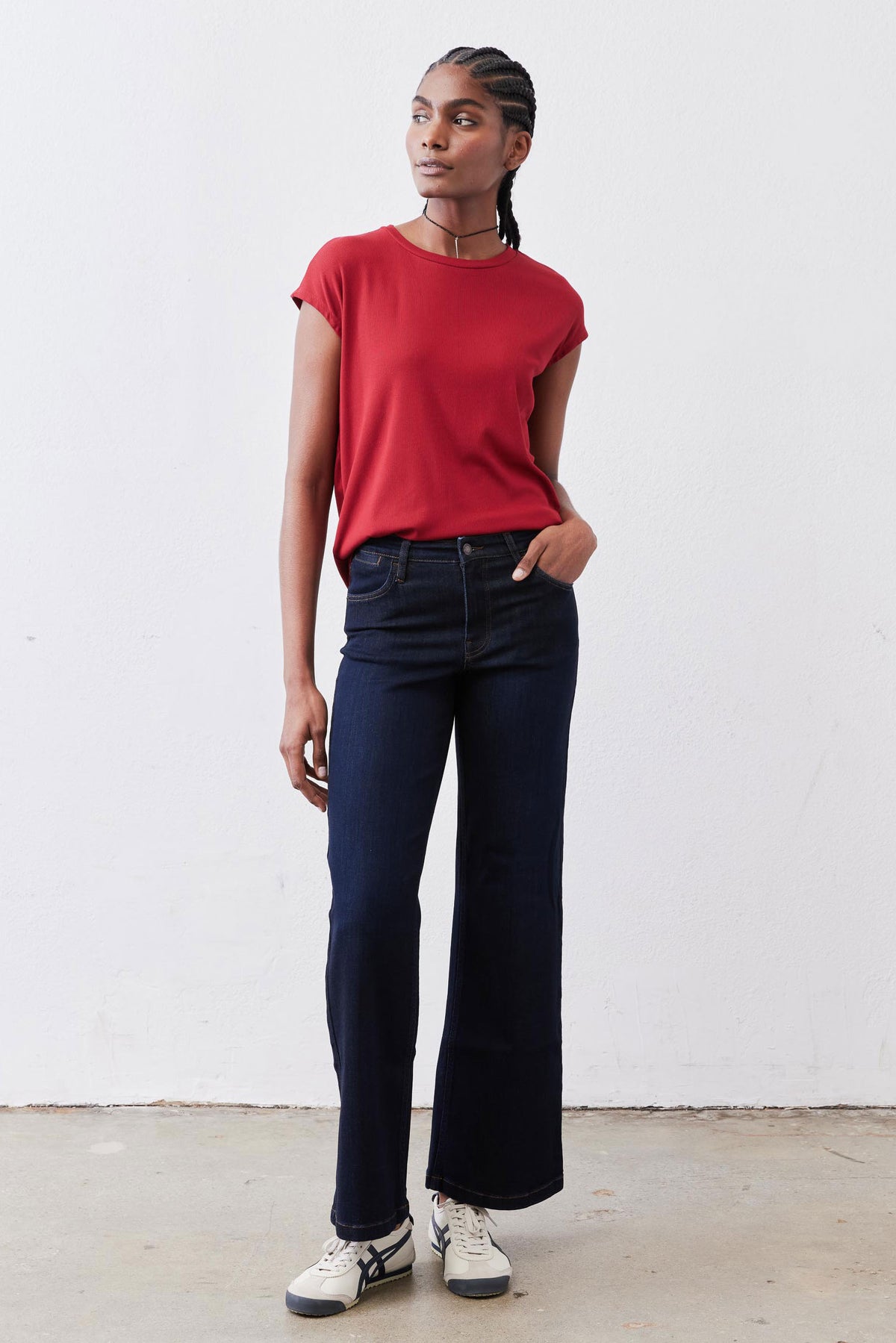 Garnet red ribbed crew-neck tee, short sleeves, tucked at waist