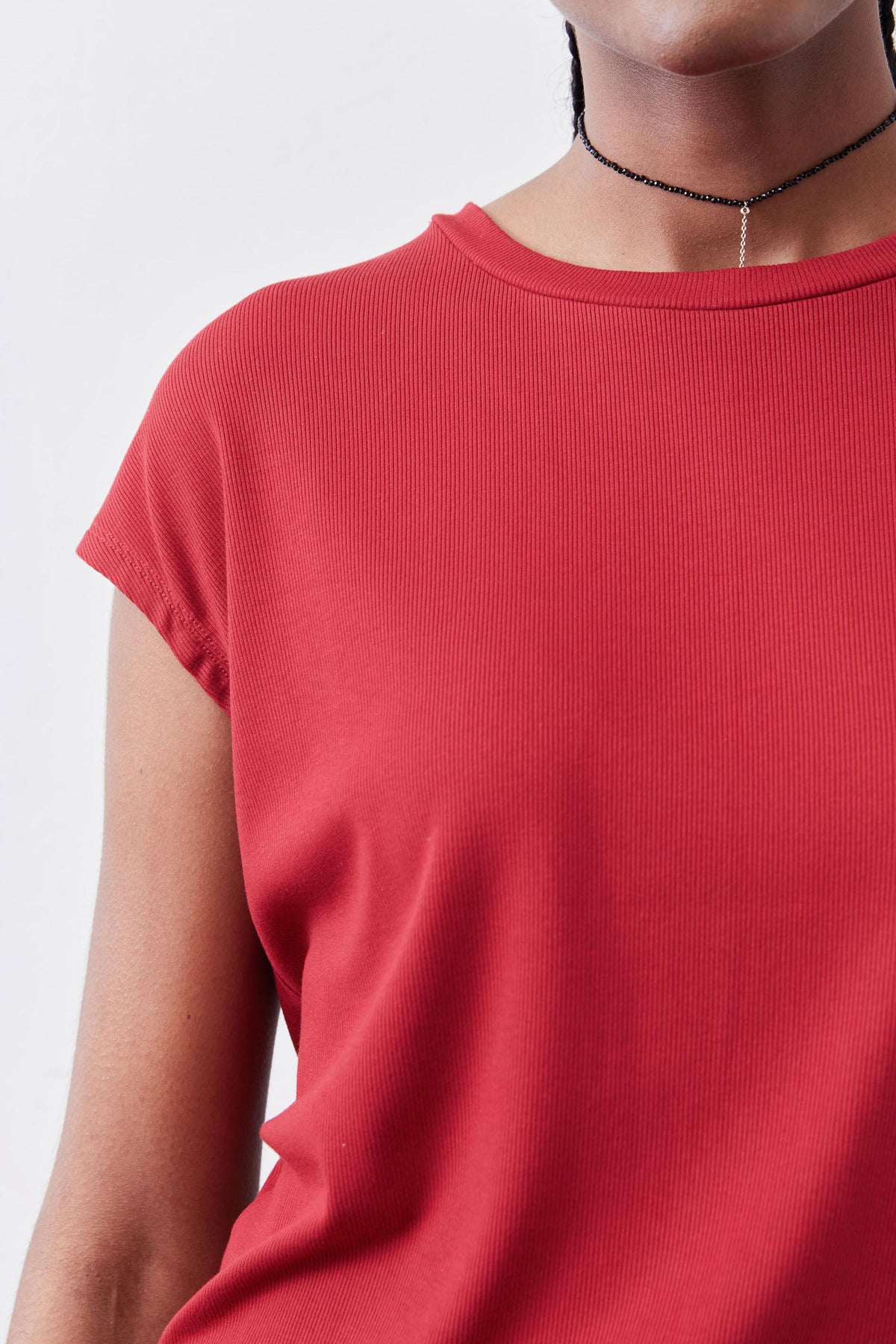 Garnet red ribbed knit tee close-up, crew-neck collar