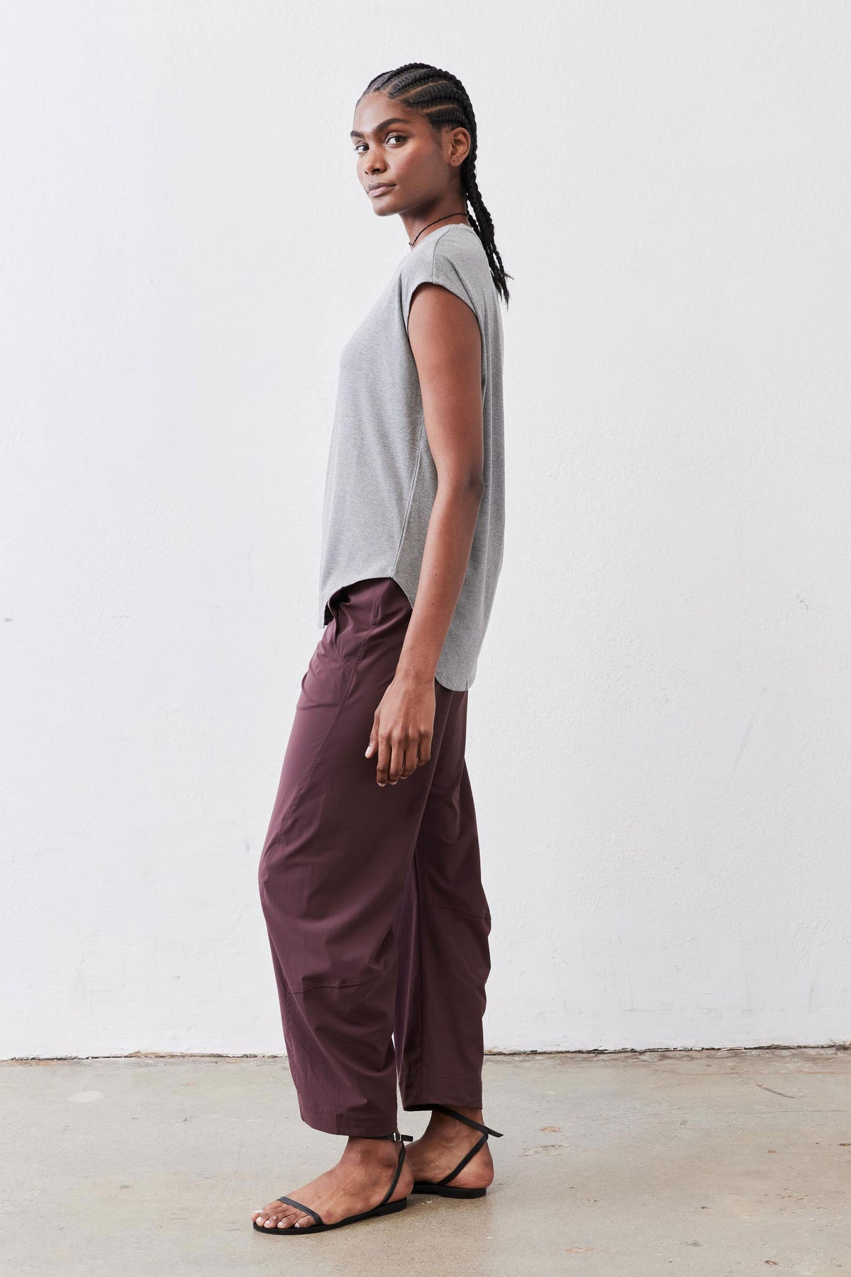 Gray melange ribbed crew-neck tee with short sleeves, side profile