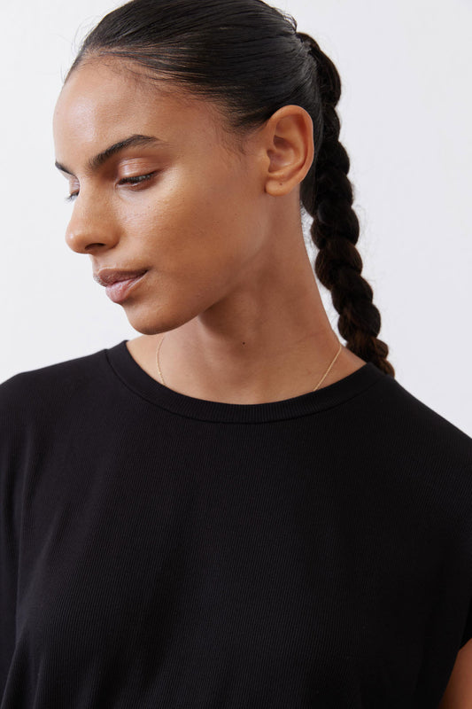 Black ribbed tuck-in tee crew neck, short sleeves, close-up on collar