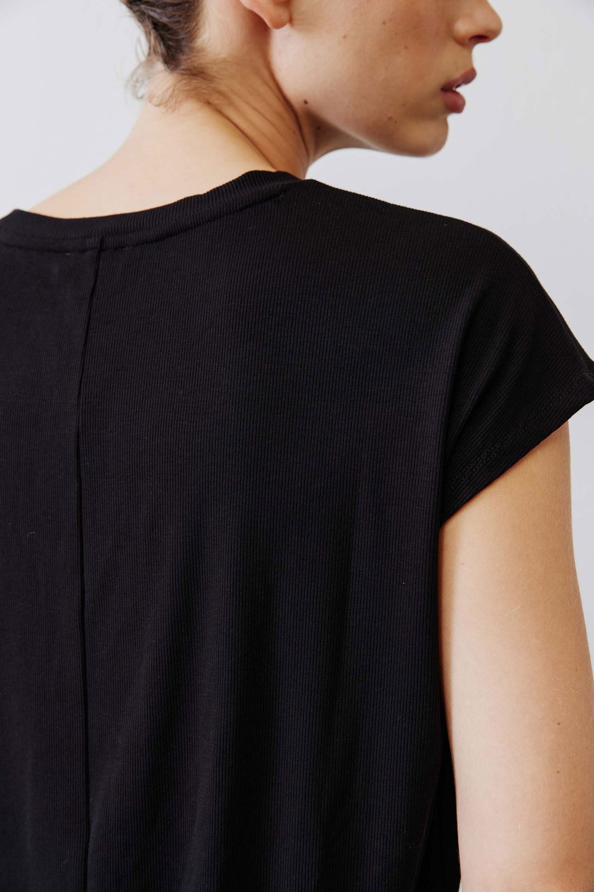 Black ribbed knit tee with center-back seam and crew neck