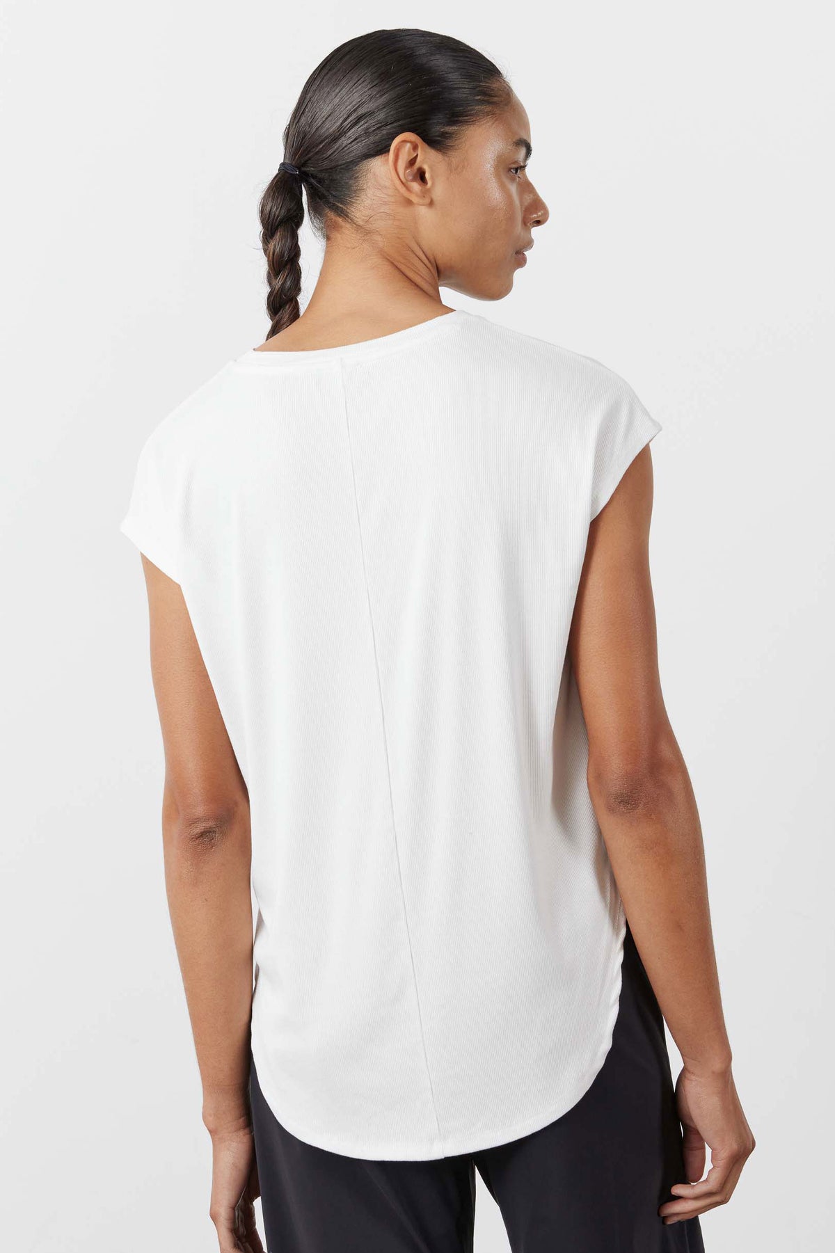White ribbed tuck-in tee, back view with center seam and curved hemline