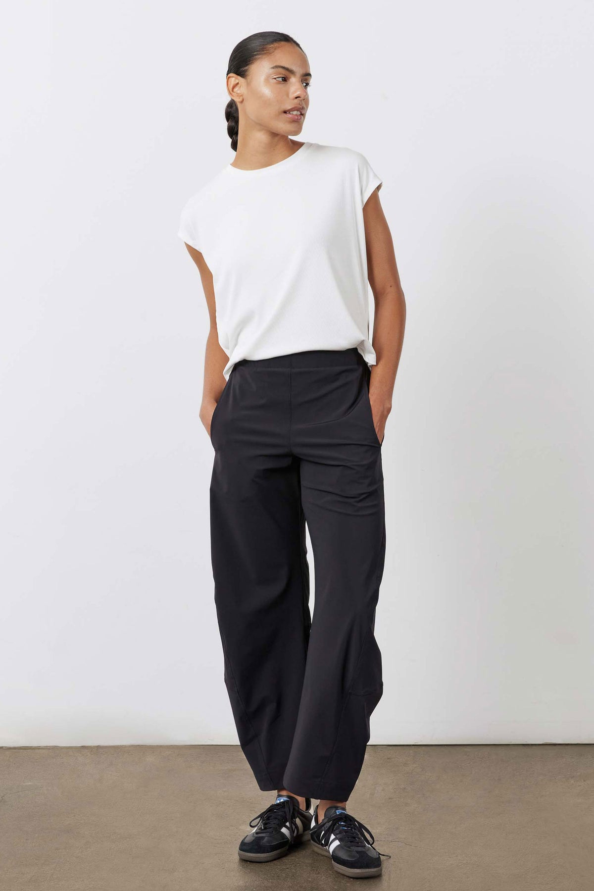 White ribbed tuck-in tee, three-quarter view with crew neck and tucked waist