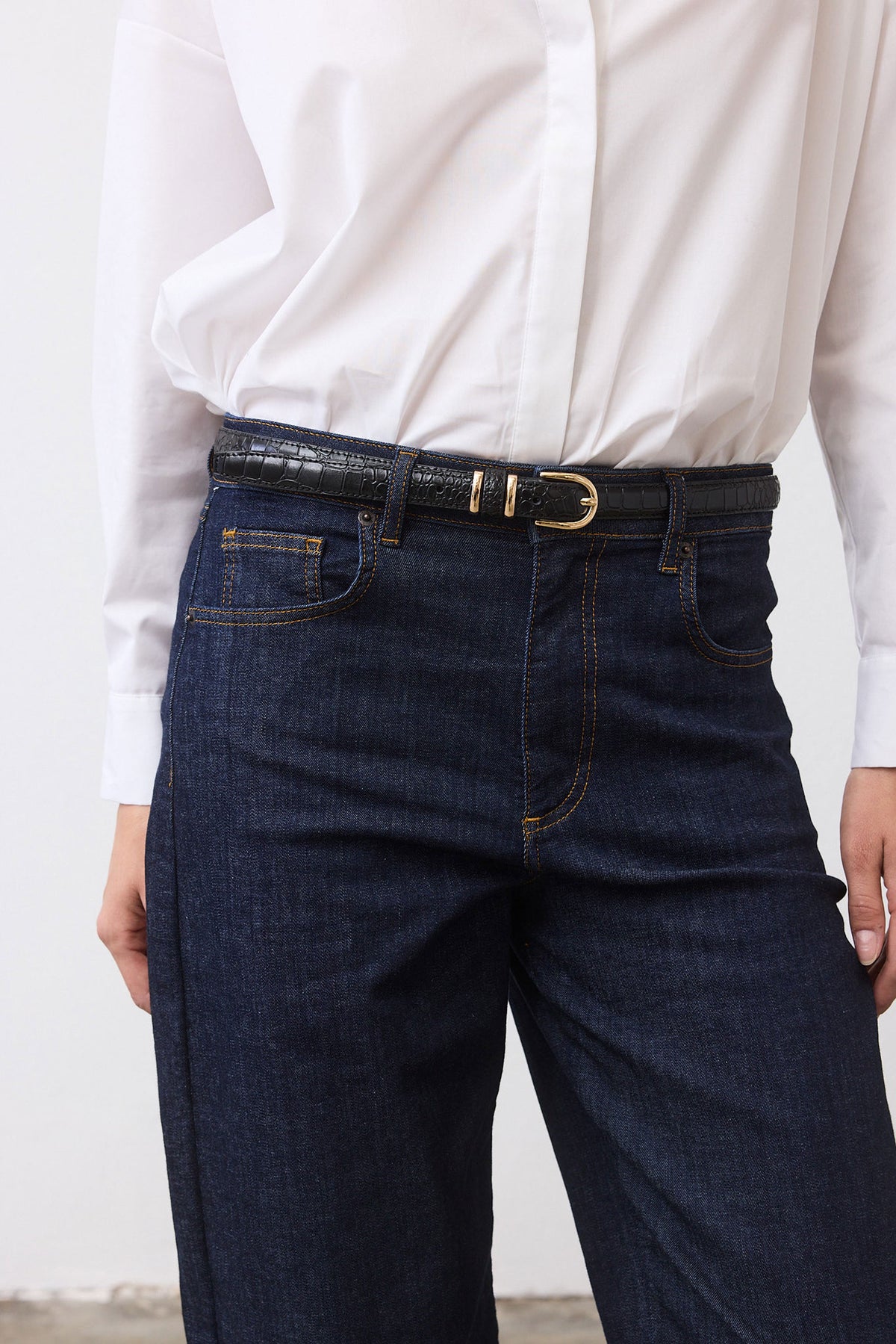Black croc-embossed belt with gold oval buckle and stitched strap