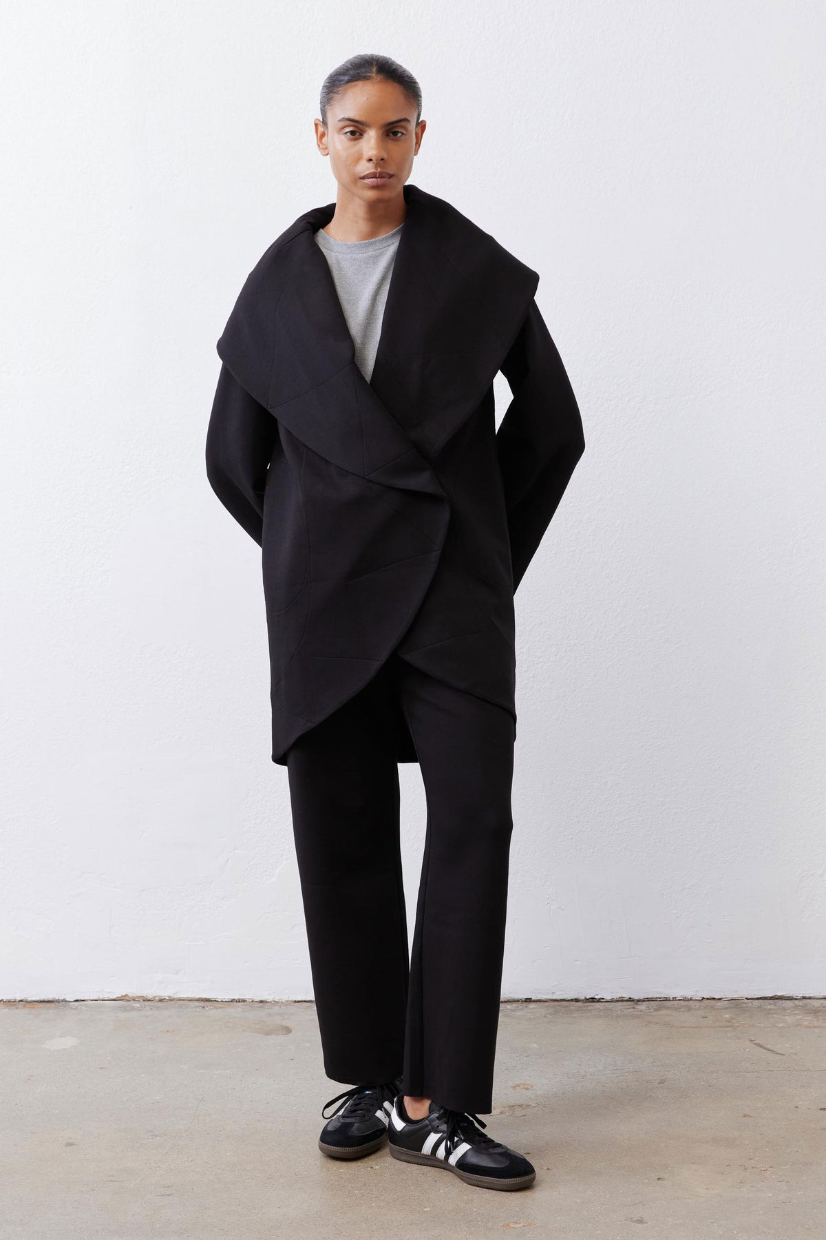 Black shawl-collar scuba coat with draped wrap front and long sleeves