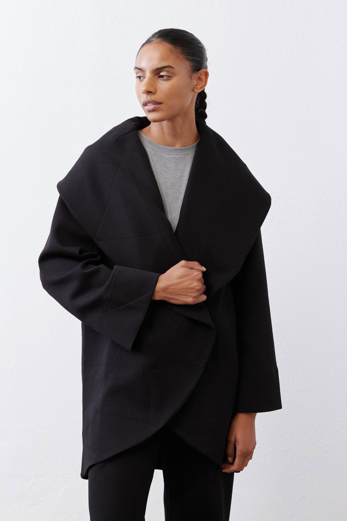 Black shawl-collar wrap coat, open front with hidden-seam detailing