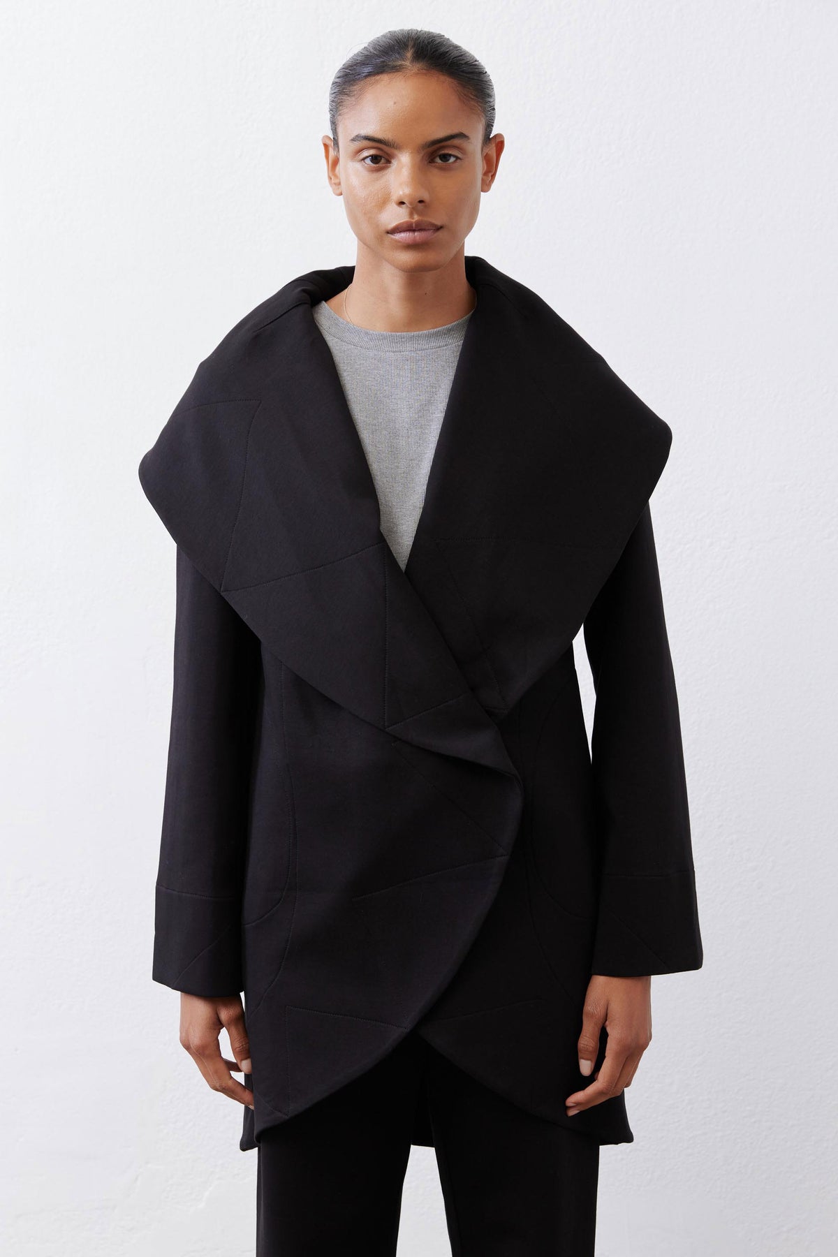 Black shawl-collar wrap coat with asymmetric drape and two front slant pockets