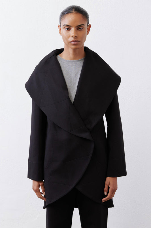 Black shawl-collar wrap coat with asymmetric drape and two front slant pockets