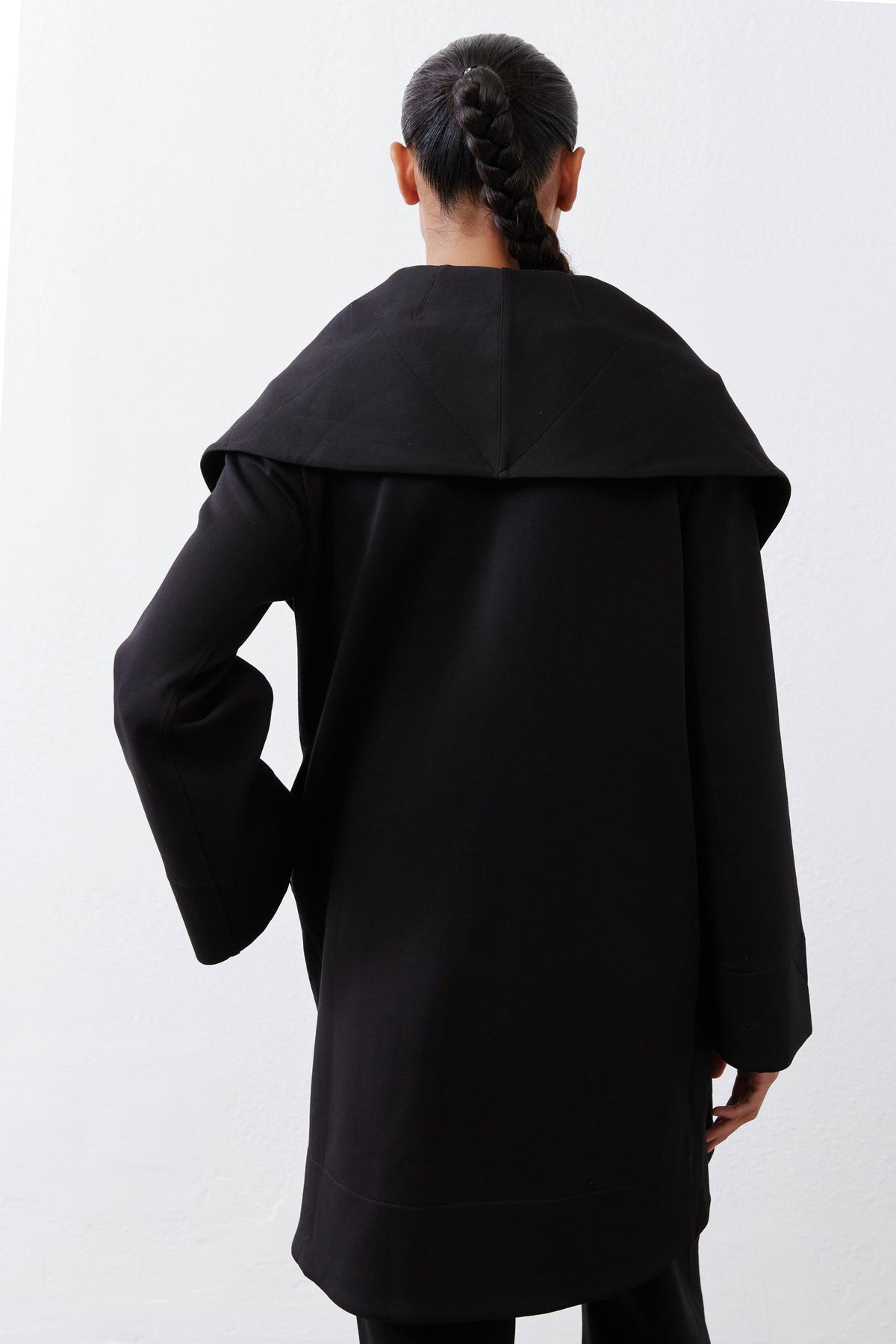 Black shawl-collar coat with back yoke seam and full-length sleeves