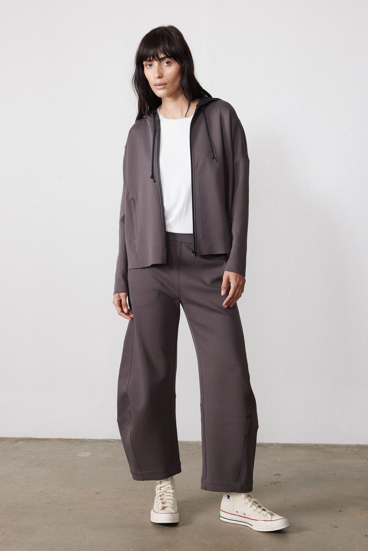 Storm gray scuba zip hoodie with drawstring hood, worn open with matching wide-leg pants.