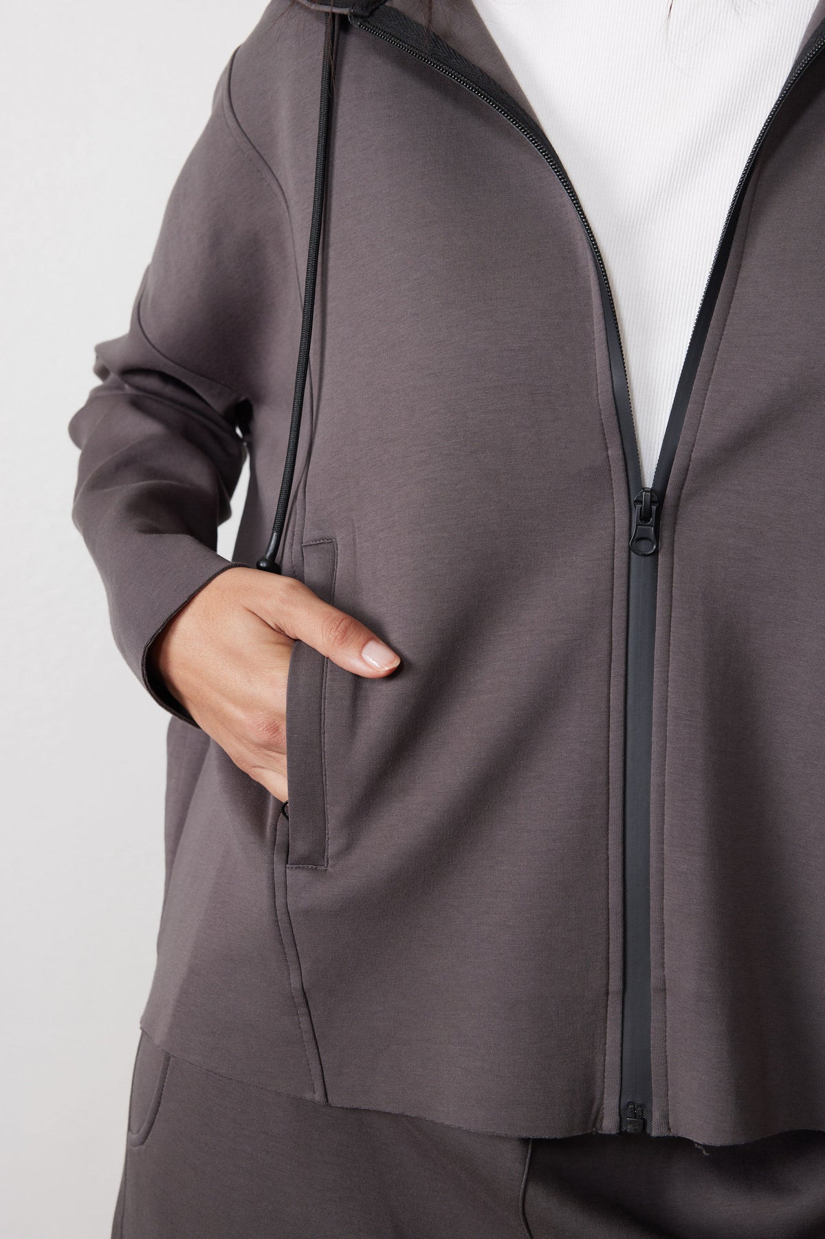 Storm gray hoodie detail showing the zipper, drawstring, and front pocket.