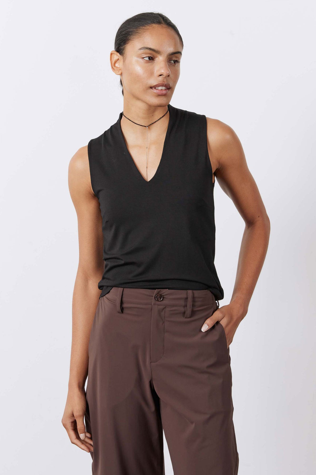 Black V-neck sleeveless tank top, side-front view