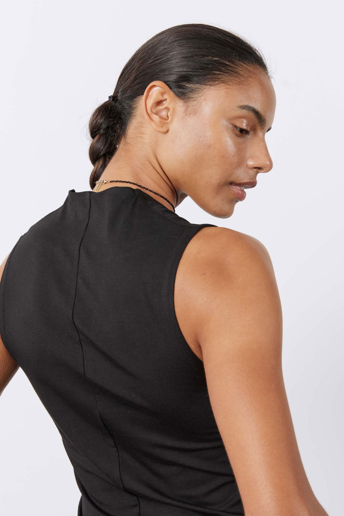 Black V-neck sleeveless tank top, back view