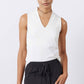 White sculpted V-neck tank top on model, sleeveless with fitted drape
