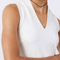 White V-neck sleeveless tank top with sculpted seams, close-up on torso.