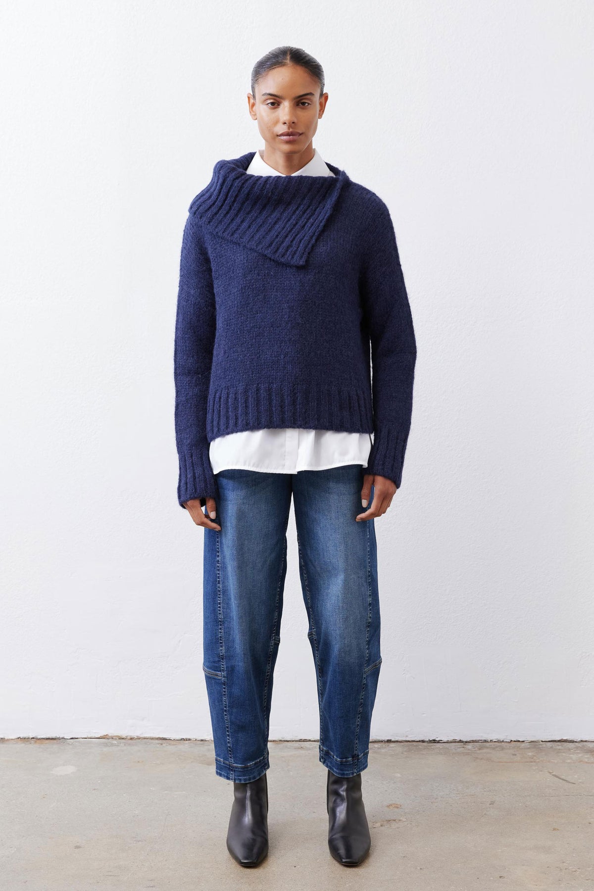 Midnight navy shawl-collar sweater with ribbed hem and cuffs, worn over jeans