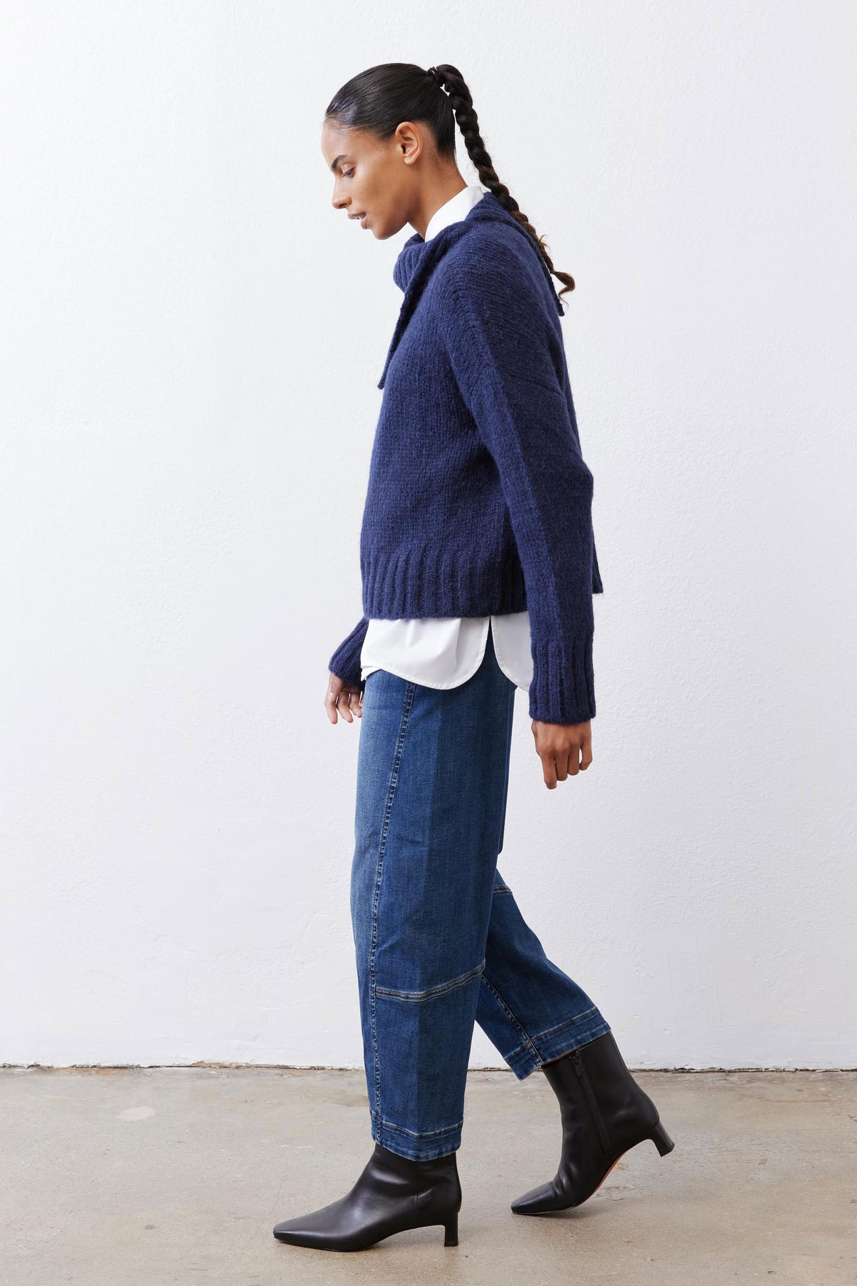 Midnight navy shawl-collar sweater shown from the side, with ribbed sleeve cuffs