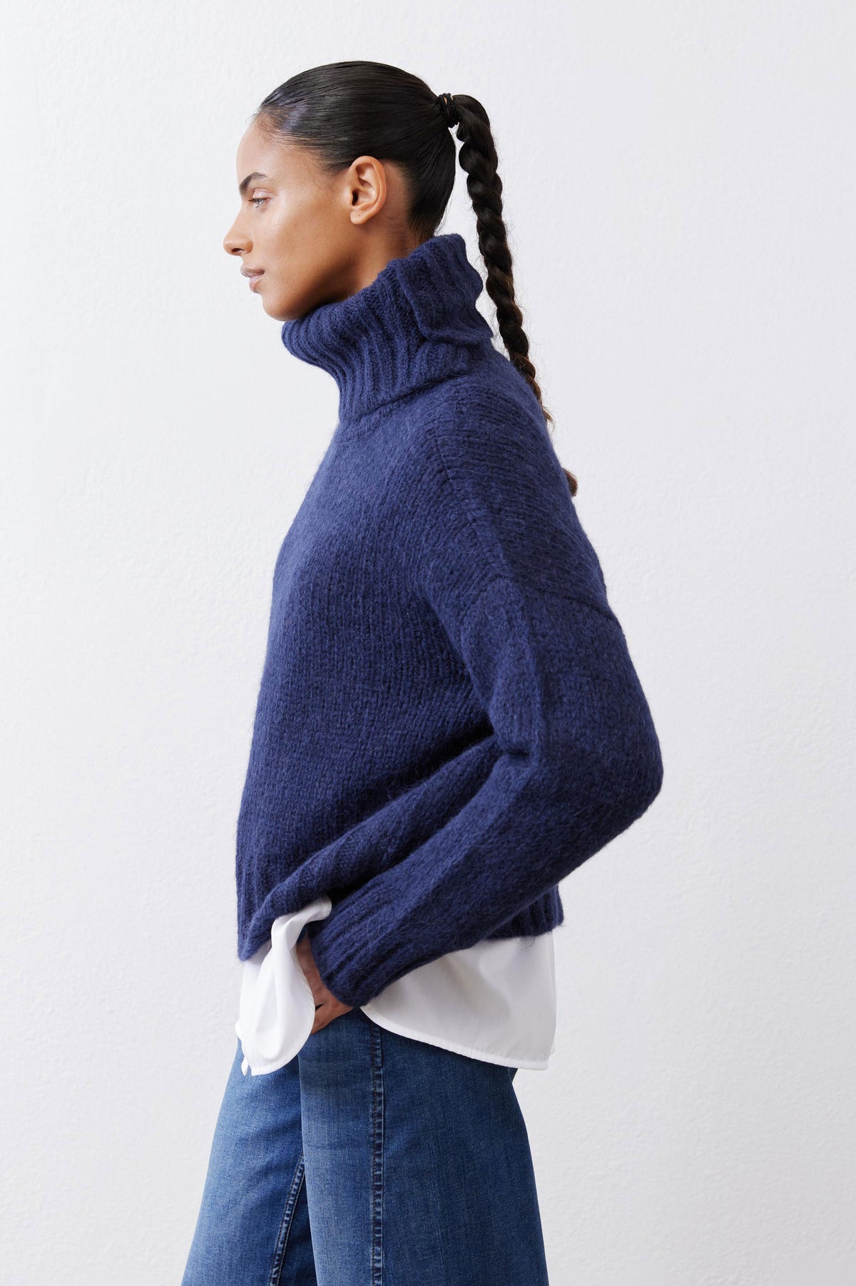 Midnight navy shawl-collar sweater from the side, draped over a white shirt