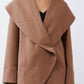 Fawn shawl-collar wrap coat detail with overlapping front and seam lines