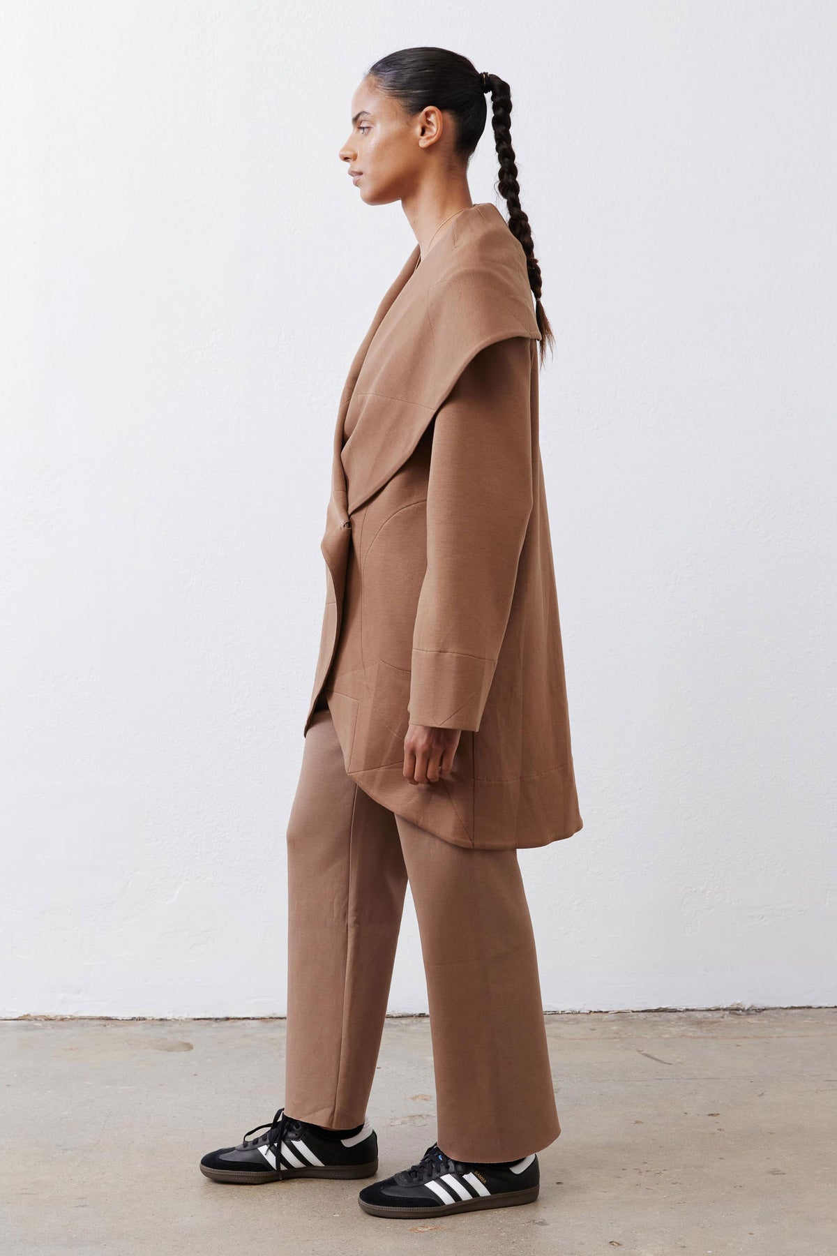Fawn shawl-collar wrap coat with long sleeves and draped side panel