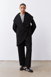 Black shawl-collar scuba coat with draped wrap front and long sleeves.
