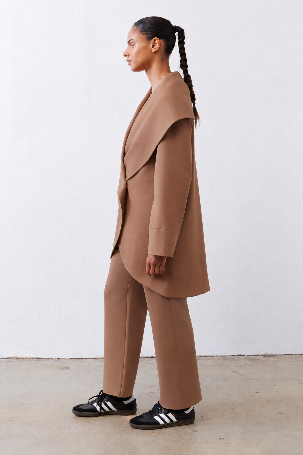 Fawn shawl-collar scuba coat, side view with draped wrap front and long sleeves