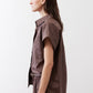 Chocolate short-sleeve button-down blouse side view with structured shoulders