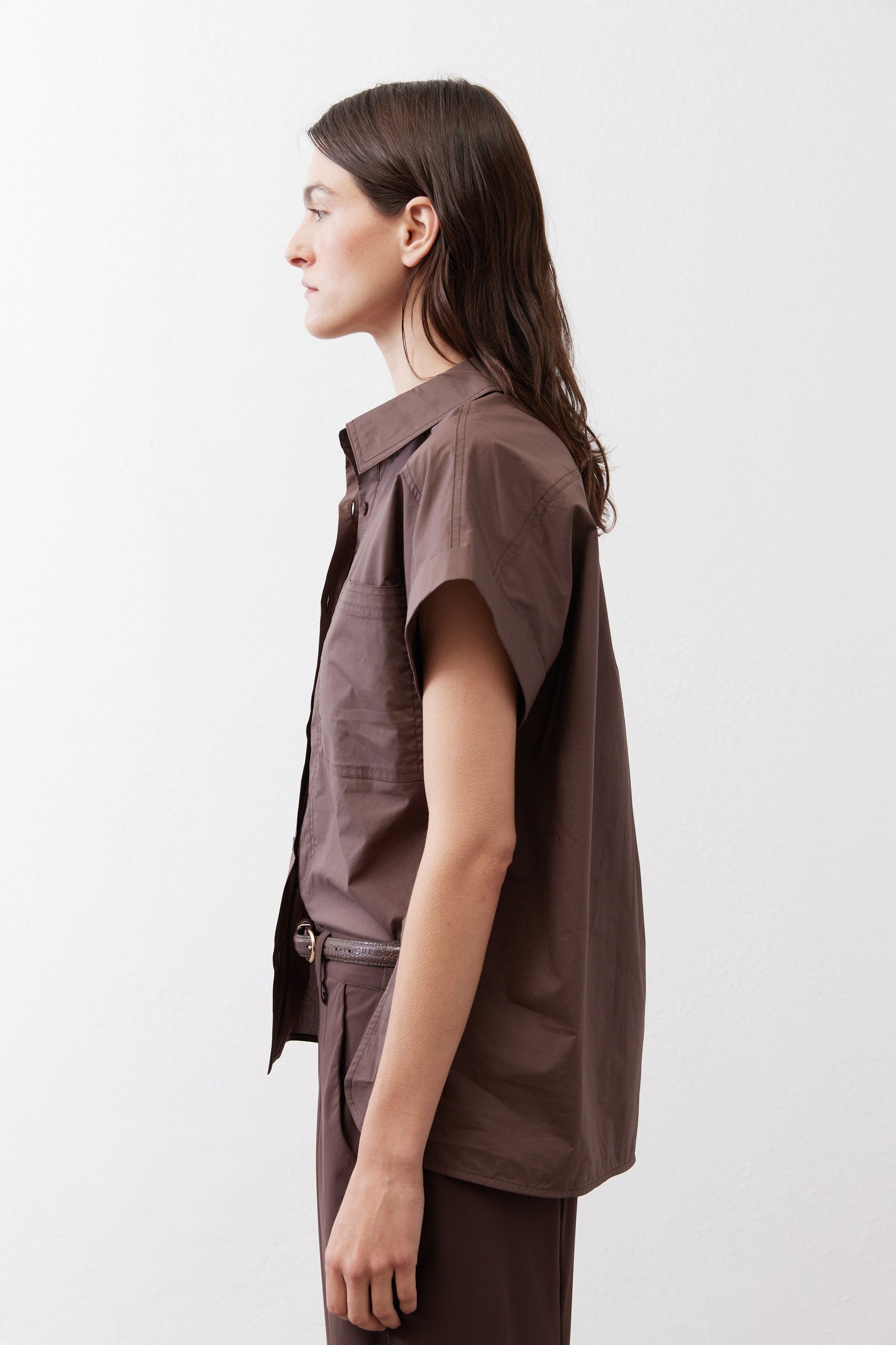 Chocolate short-sleeve button-down blouse side view with structured shoulders