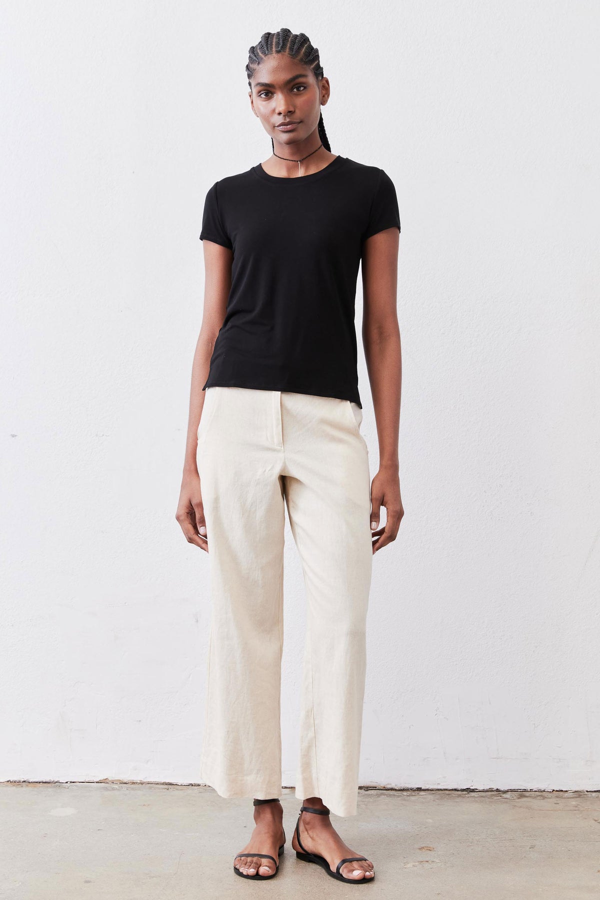 Black short-sleeve crew neck tee, smooth fit with even hem and sleeves