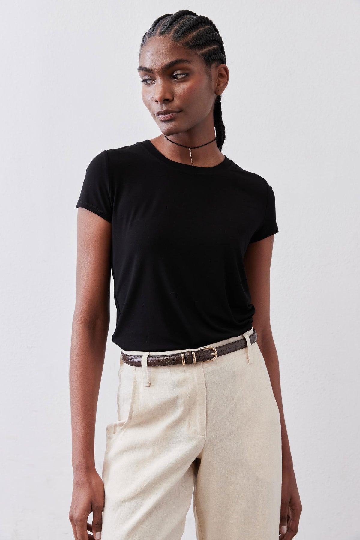Black crew neck short-sleeve tee on upper body, fitted around shoulders