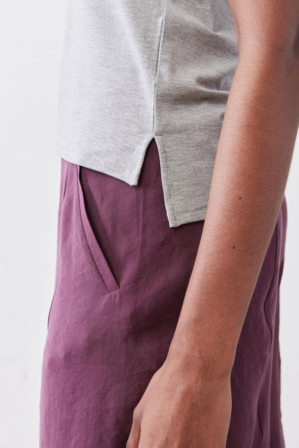 Gray crew neck tee with short sleeves and curved side hem detail.