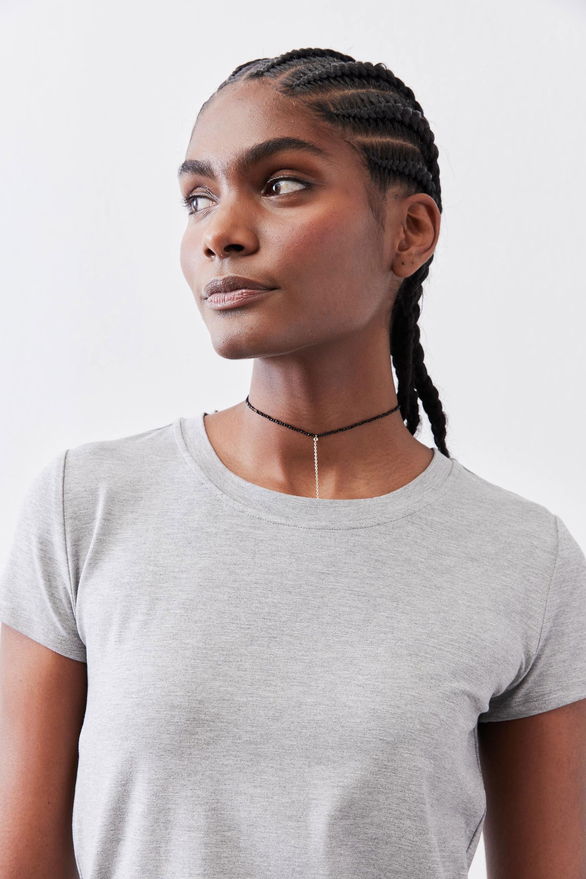 Gray crew neck tee close-up of neckline and short sleeves.