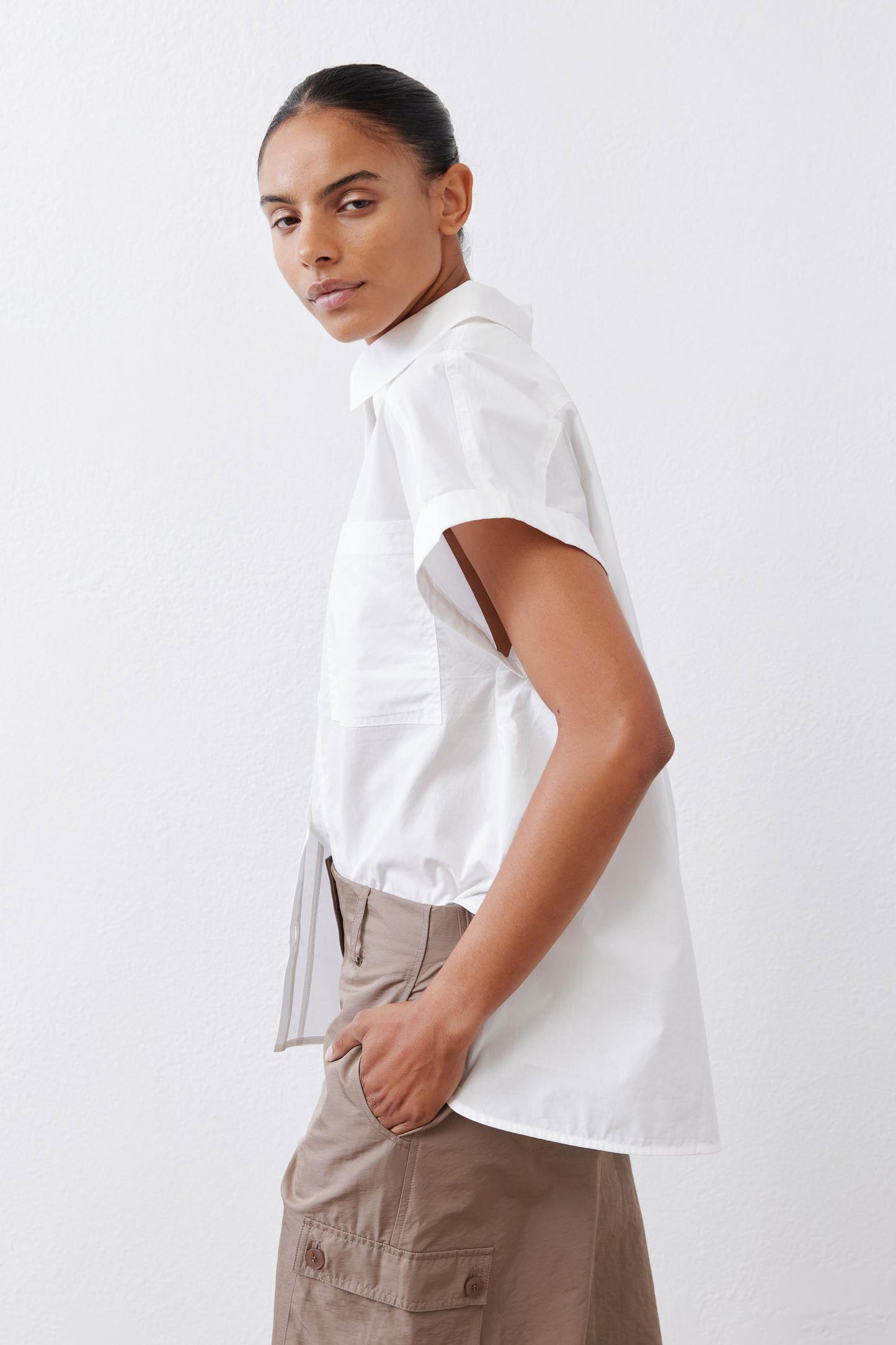 White short-sleeve button-down blouse, side view with high collar