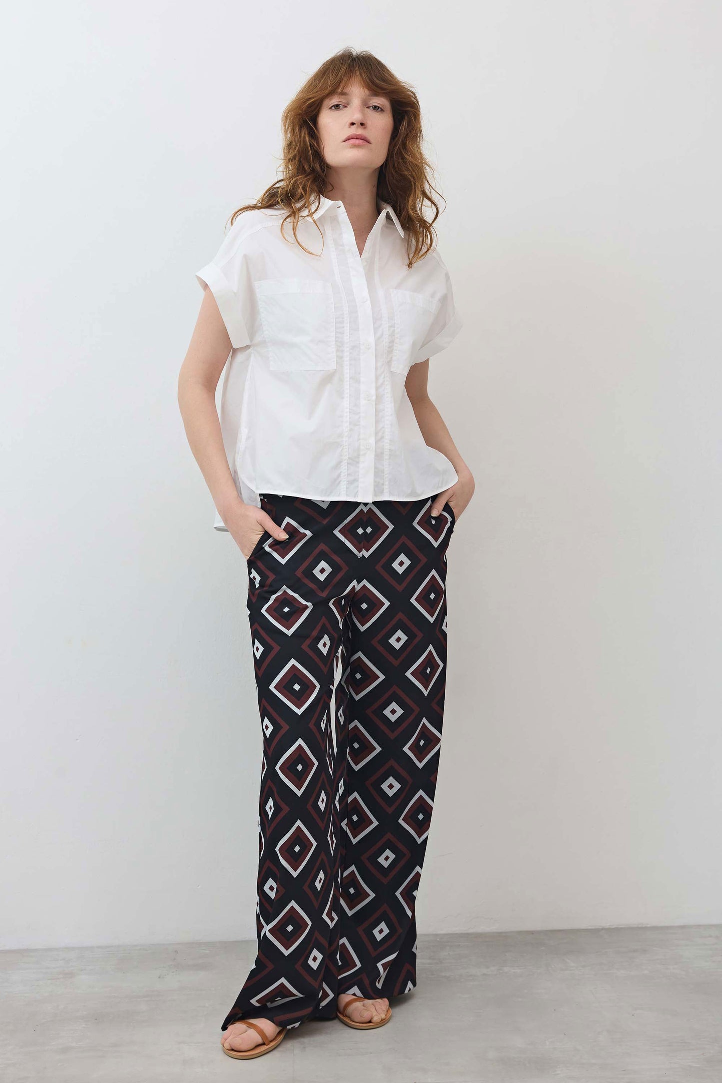 White short-sleeve button-down blouse with pointed collar and stitched chest pocket