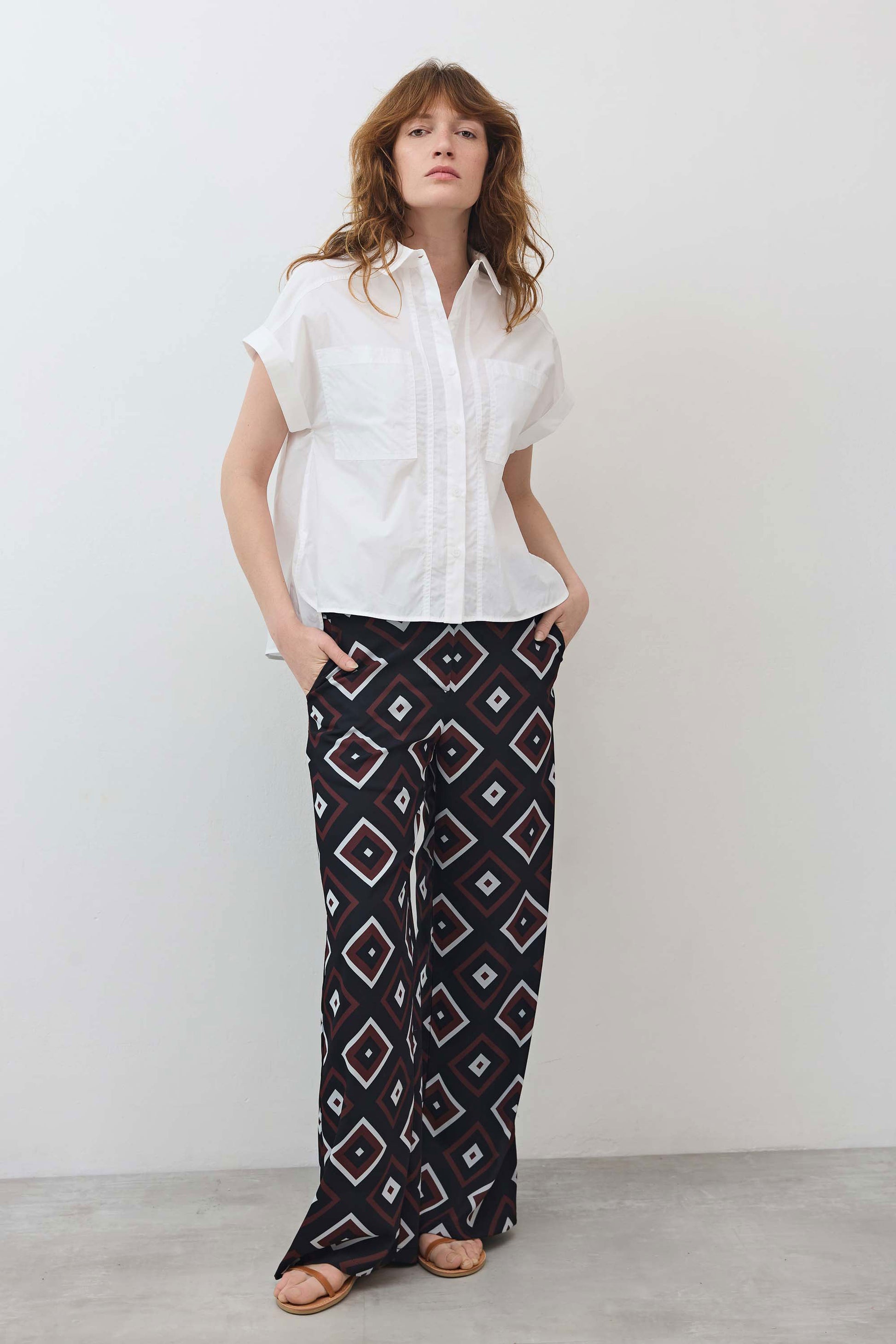 White short-sleeve button-down blouse with pointed collar and stitched chest pocket