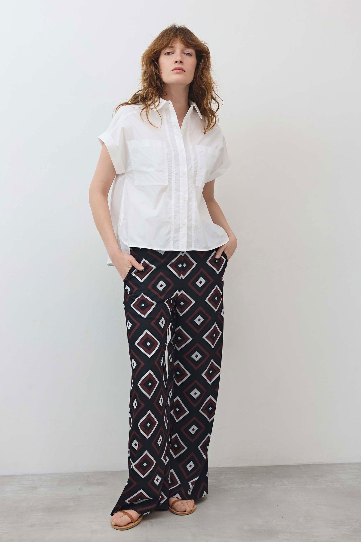 White short-sleeve button-down blouse with pointed collar and stitched chest pocket