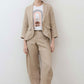 Loose linen pants in light beige with elastic waistband and relaxed straight-leg silhouette